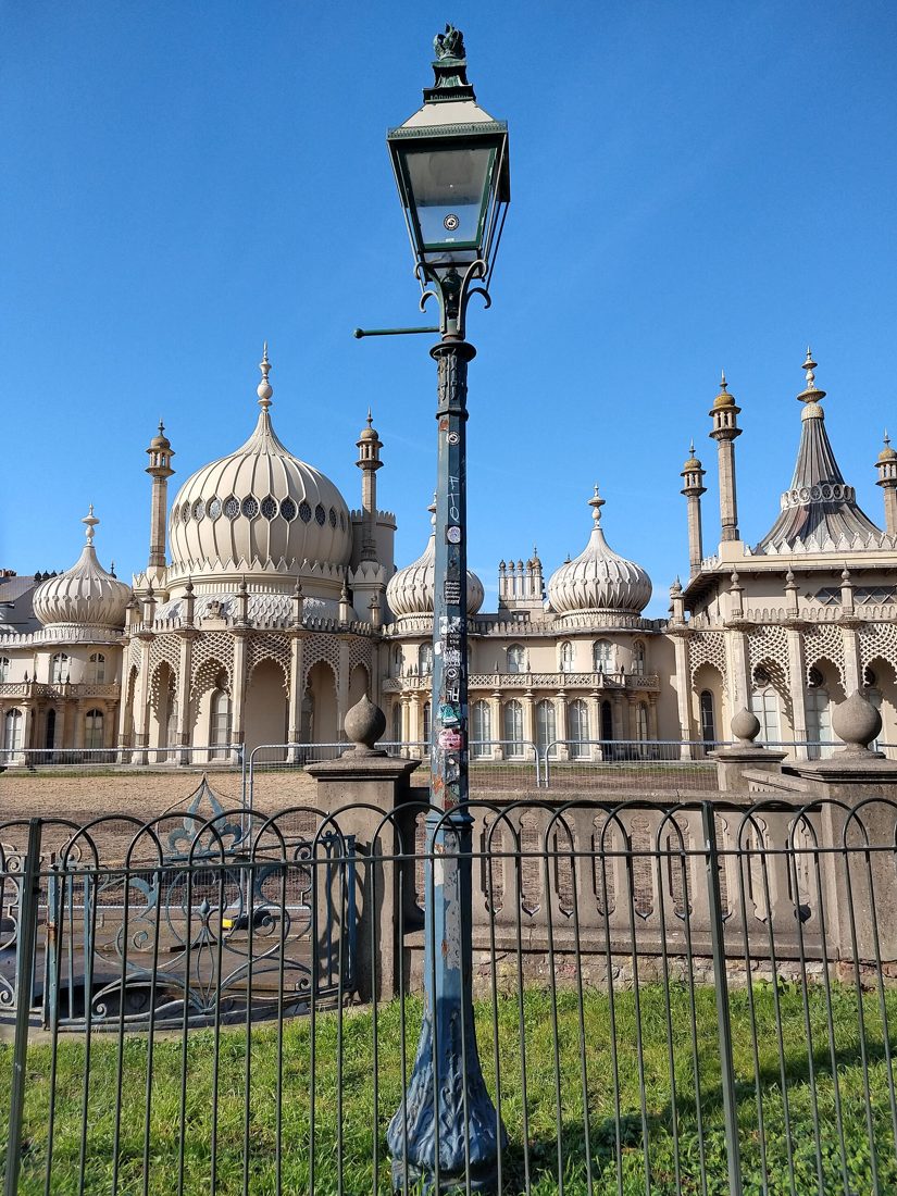 The domes and minarets of the Royal Pavilion in Brighton against a blue sky.
