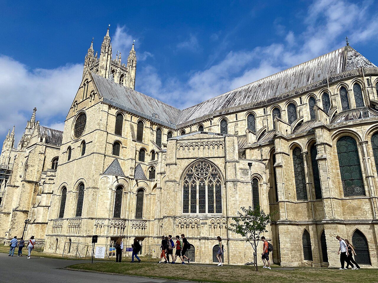 The towers and west front of Canterbury Cathedral above the precinct roofs.